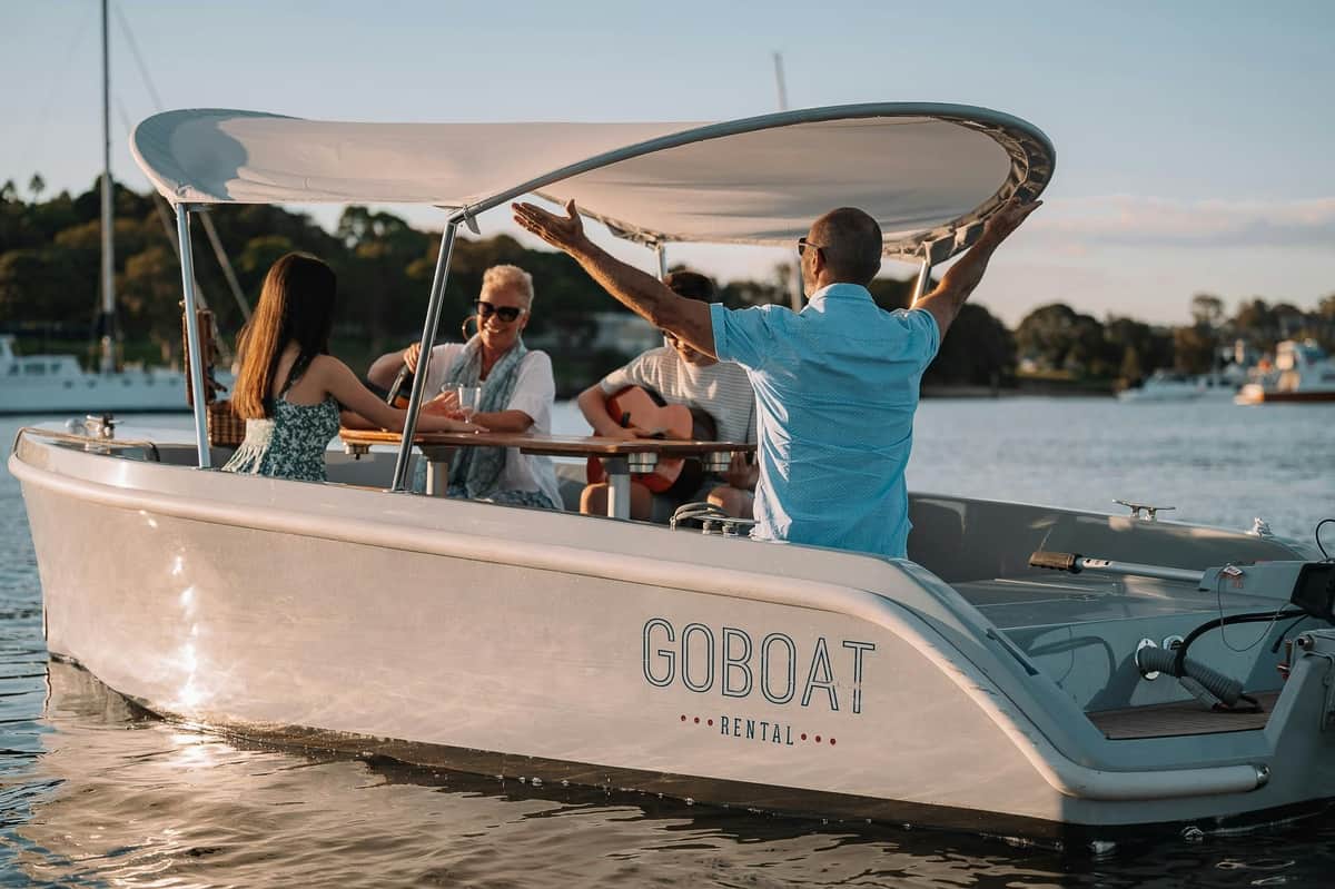 Sydney: Private Electric Boat Rental from Cabarita Point A GoBoat sailing with four guests onboard sharing stories over a bottle of wine