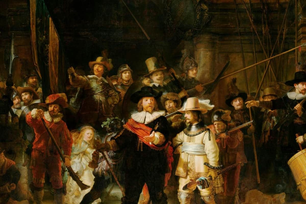 Amsterdam: Canal Cruise with Audio Guide + Rijksmuseum Entry A group of people dressed in historical attire, some armed with weapons, gathered in a dimly lit setting.